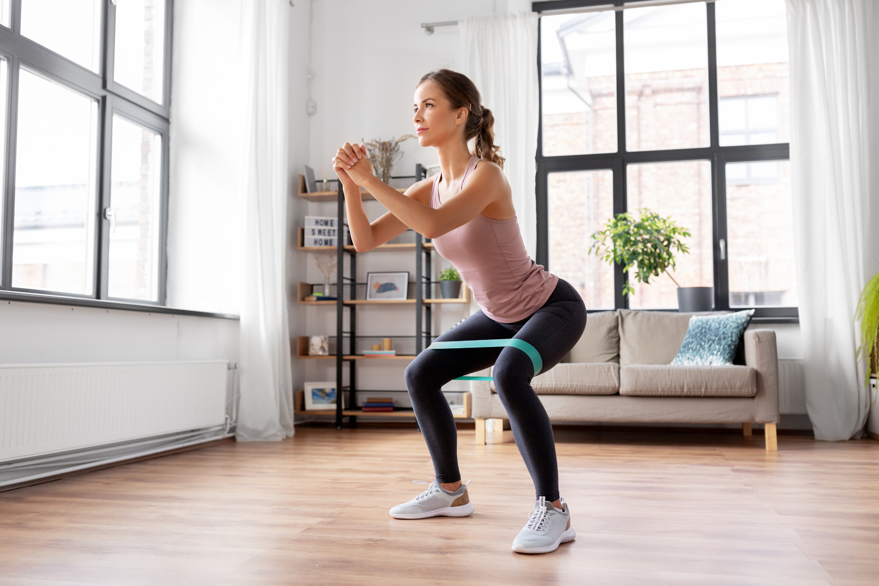 Woman Exercising with Resistance Band at Home